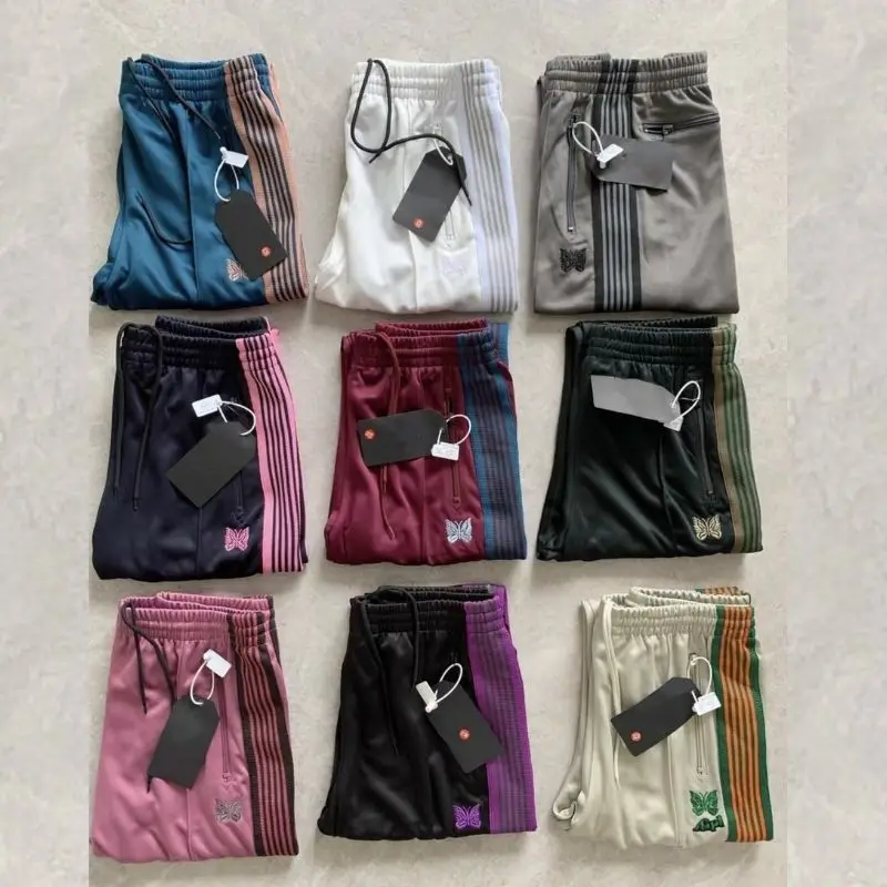 1: 1 Vysoko kvalitné vyšívané motýľové bočné pruhy Strepky Unisex Cast Track Pants so značkami Men Ženy Športové nohavice