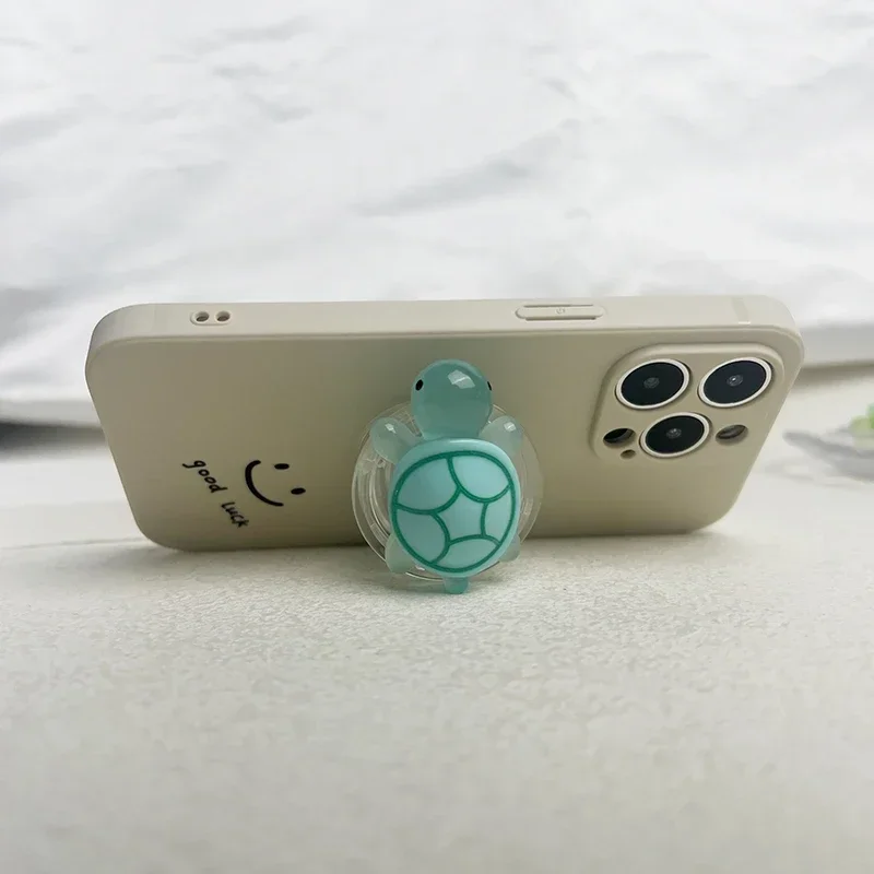 1PC GLOW-In-the-the Turtle Držiteľ telefónu Mini Resin Turtle Dizajn rozšíriteľný skladací stojan, ktorý nekĺzne ABS Grip pre mobilné zariadenia