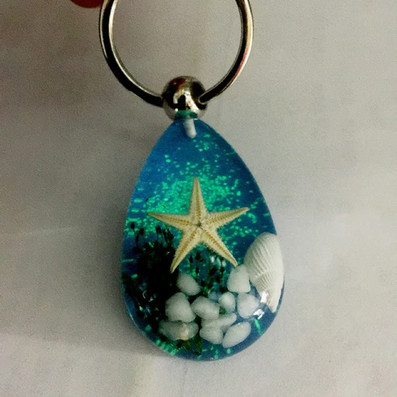 Novinka nová módna žiarivá škrupina Starfish Charm Keychain pre ženy modré morské krištáľové kľúče reťazce Men Darček pre šperky